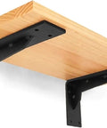 Badass Black Industrial Floating Shelf Brackets Two Pack with thick steel L corner mounts holding a wooden shelf.