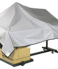 Badass 72 By 112 Inch Machine Cover Built From Tough Cotton Plastisol Fabric protecting a workbench from dust and moisture.