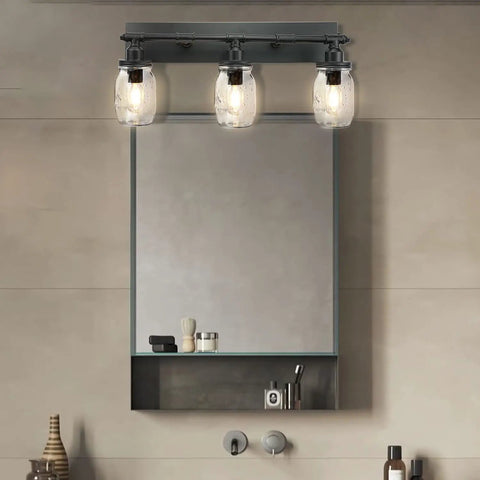 Industrial Mason Jar Vanity Light Wall Sconce In Black Finish above bathroom mirror, three light fixture with glass jar shades.