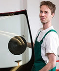 Person using 9 Inch Vacuum Concave Suction Cup Glass Lifter with Handle on auto windshield.