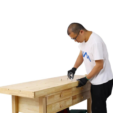 Person working on 64.5 Inch Heavy Duty Rubber Wood Workbench With 4 Storage Drawers Adjustable Vise Solid Wood Work Table