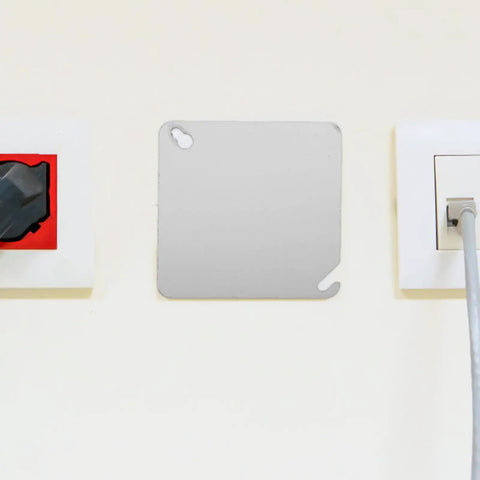 Installed 4 Pack Square Electrical Box Cover Plates for blank control panels or junction boxes in an office setting