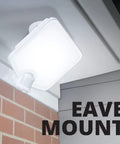 Hyper Bright LED Motion Activated Security Flood Light in Bronze mounted on eave, illuminating outdoor area