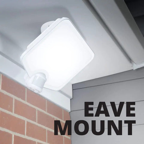 Hyper Bright LED Motion Activated Security Flood Light in Bronze mounted on eave, illuminating outdoor area