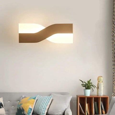 UPRENXIAO Modern Minimalist Nordic Led Wall Sconce Wavy Twisted Design Baked illuminating a living room with soft light.