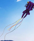 Purple Giant 3D Goldfish Frameless Soft Parafoil Kite flying in the sky, includes 50m line and two colorful tails, ideal for outdoor use