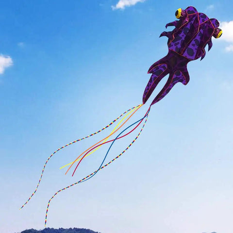 Purple Giant 3D Goldfish Frameless Soft Parafoil Kite flying in the sky, includes 50m line and two colorful tails, ideal for outdoor use