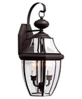 Lancaster Traditional Two Light Outdoor Wall Lantern In Polished Brass Finish, classic design on a porch, clear beveled glass