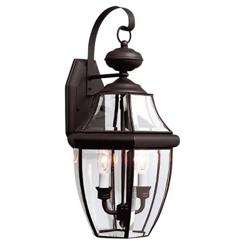 Lancaster Traditional Two Light Outdoor Wall Lantern In Polished Brass Finish, classic design on a porch, clear beveled glass