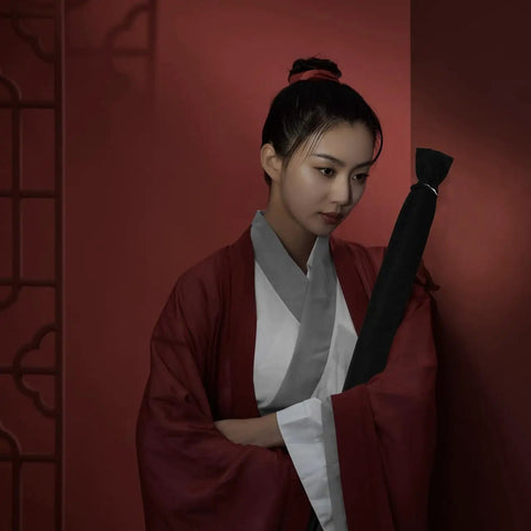 Person holding 65 Inch Sword Back Bag Cover for Katana and Shinai Travel Case with Shoulder Strap in a martial arts setting.