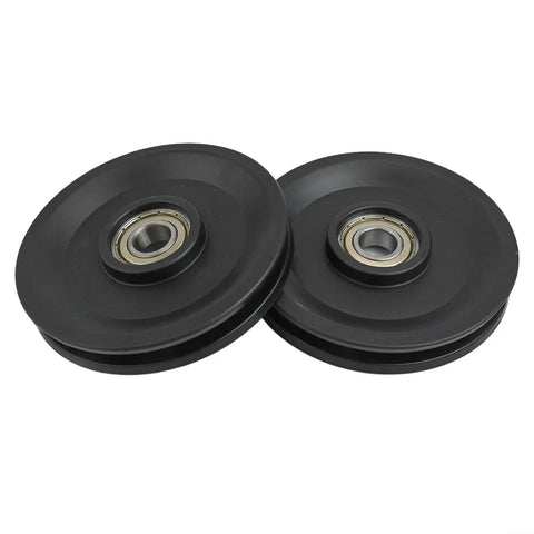 Two black smooth finish Beefy Nylon Bearing Pulley Wheels with 112.5mm outer diameter for cable machines, weightlifting systems.