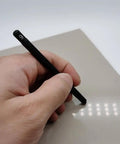 Solid Seven Piece Mohs Hardness Scratch Test Pen being used on a surface for mineral ID and testing.