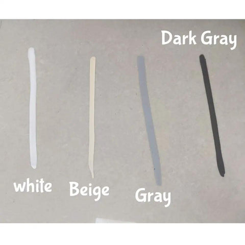 Sample markings of white, beige, gray, and dark gray colors on a surface, demonstrating grout renewal pen options.