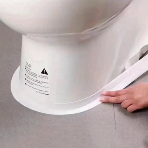 Person applying Heavy Duty PVC Sealing Tape For Kitchen Sink And Bathroom Waterproof Oil Proof Caulk Strip to toilet base.