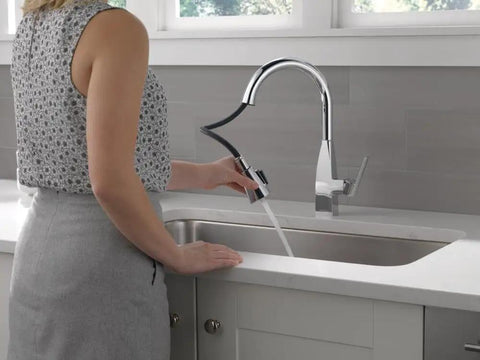Woman using Xander Single-Handle Chrome Kitchen Faucet With Pull-Down Sprayer Easy Install For 1-Hole Or 3-Hole Sinks