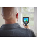User operating 12V Max Connected Thermal Camera With 500 Sharp Thermal Images Storage For On Site Inspections indoors.