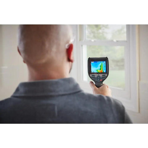User operating 12V Max Connected Thermal Camera With 500 Sharp Thermal Images Storage For On Site Inspections indoors.