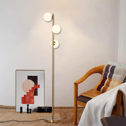 Three Globe Brushed Brass Floor Lamp, Modern LED Standing Light For Living Room, Bedroom, And Office, room setting