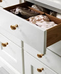 Golden Wave Shaped Cabinet Pulls Set Of 6 With Glossy Cupboard Drawer Knobs on white drawer in kitchen