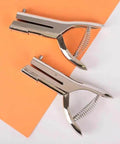 Tough As Nails Single Hole Punch For Crafts And Scrapbooks, Quarter Inch Hole Puncher In Zinc Alloy, shown on orange paper.