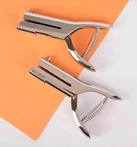 Tough As Nails Single Hole Punch For Crafts And Scrapbooks, Quarter Inch Hole Puncher In Zinc Alloy, shown on orange paper.