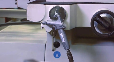 Jet Guard 74S Safety Air Blow Gun with 74S Air Cone Nozzle hanging on machinery in workshop setting.
