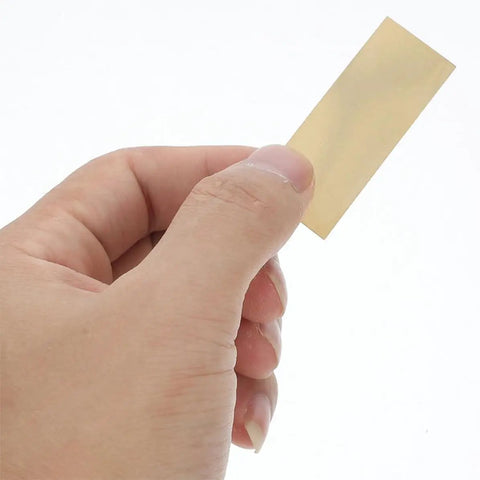 Hand holding a copper electrode strip from Copper And Zinc Electrode Strips 20 Pcs DIY Science Kit For Classrooms And Labs