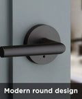Milan Matte Black Iron Door Lever, Dope Modern Slim Round Privacy Handle installed on interior door showing modern round design.