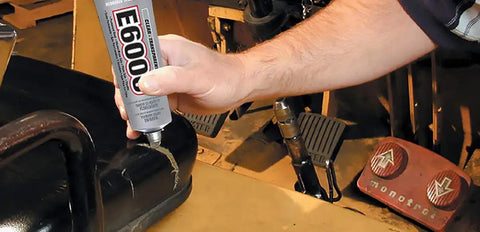 Person applying Hi Visc 3.7-Ounce Adhesive Go-To Bond For Tough Projects 2x Stronger And 60x More Flexible Than Polyurethane on equipment.