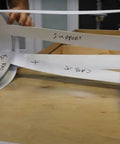 Person using Template Material Kit with 20 strips for DIY countertops showers cabinets and tables to create custom templates.