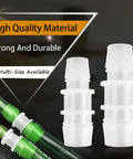 Front view of hose barb fittings set, white plastic connectors with green tubing, two multi-size aquarium reducers.