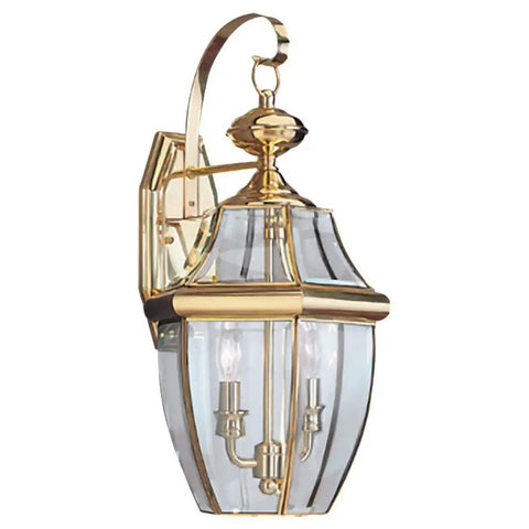 Lancaster Traditional Two Light Outdoor Wall Lantern In Polished Brass Finish No Fuss LED Upgrade Ready Classic Exterior Fixture For Porch Or Patio Weather Resistant Outdoor Lighting features clear beveled glass and a traditional design.