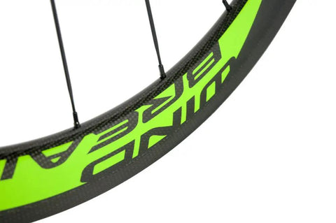 Close-up of R13 hub decal on carbon fiber road wheelset clincher 50mm depth with basalt braking surface and V brake ready rims.