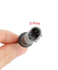 Close-up of rear brake pad wear sensor connector, 2-pin, black, fits BMW i3 (2014-2017)