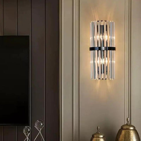 Top Shelf Crystal Wall Sconces With Brushed Black Metal And Sleek Bedroom Vanity Light For Bathroom Fixture Modern Bedside Lamp For Dining Room Decor Heavy Duty Build With Fresh Vibes mounted on beige wall beside gold decor.  