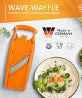 Orange Börner Wave-Waffle vegetable slicer with crinkle-cut blades and plastic frame.
