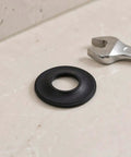 10pcs Pop up Bathtub Stopper Gasket Rubber Sealing Washer for Drains on a countertop next to a wrench.