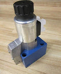 Proportional hydraulic solenoid valve M-3SEW10U14 size 10 single unit 80/96 VDC 30W control spool assembly R978914241 on wood surface