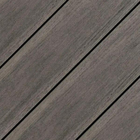 Fifty Pack Top Shelf Composite Decking Plugs In Rich Black Walnut Shade precision cut for hidden anchors on grey deck surface.