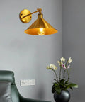 Built Tough Industrial Metal Swing Arm Wall Sconce Adjustable E27 Light Fixture Reinforced Mount with warm gold finish for living room.