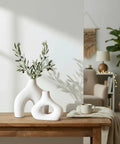 Donut Vase Set Of 2 White Ceramic Vases Large Nordic Minimalist Hollow Centerpieces on wood table with olive plant display