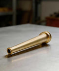 Built Tough Brass Fire Hose Nozzle One And A Half Inch Npt Thread High Pressure Firefighting Sprinkler Control Valve nozzle close-up on metal surface.