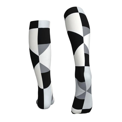 High Performance Unisex Athletic Compression Socks Featuring Graded Ankle Support Breathable Moisture Wicking Fabric Black White Piano Plate Grid Design, side view.