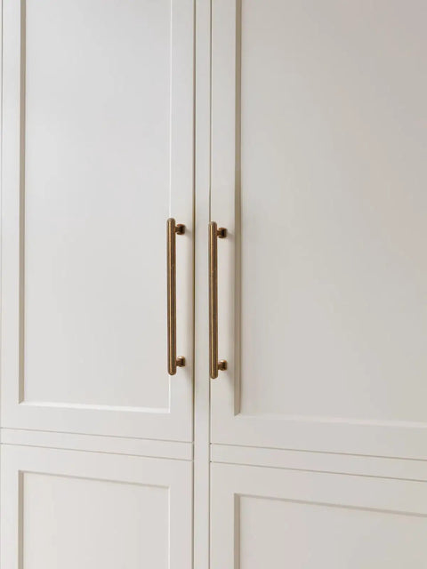 Five Pack 7.56 Inch Antique Brass Cabinet Pulls on white kitchen cupboards
