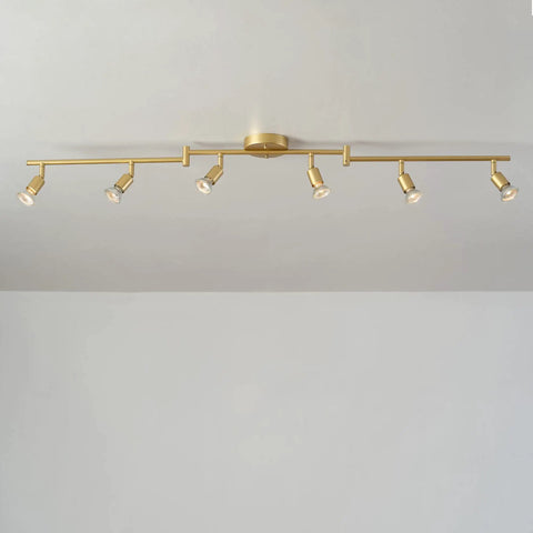 Payton 6-Light Foldable Track Lighting in Painted Brass with Exposed Sockets installed on a ceiling showcasing minimalist style.
