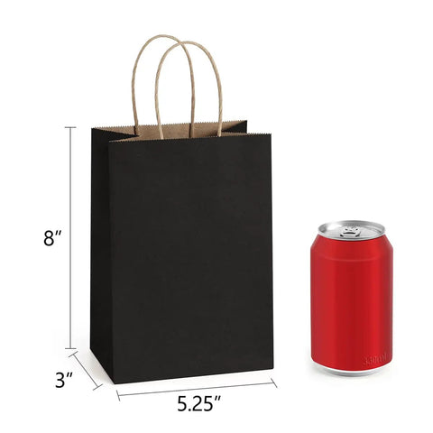 Bulk 25 Pack Black Kraft Gift Bags With Handles 5.25x3x8 Inches Eco Friendly Recycled Paper next to a soda can for size reference.