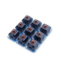 Nine Piece Key Switch Breakout Prototype PCB Board Compatible With Cherry MX For DIY Mechanical Keyboard Projects And Breadboard Prototyping With Full Pin Compatibility And Easy Hookups blue PCB with nine Cherry MX switch sockets