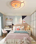 Sleek Ultra Slim Ceiling Fan And Lighting Combo Delivers Smooth Air Circulation For Modern Bedrooms And Living Spaces above a pink bed.