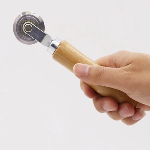 Hand holding Precise 0.5mm Cardboard Scoring Tool with durable metal wheel and oak handle, ergonomic 6.3 inch DIY tool