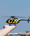 MD500 Style RC Helicopter for Adults, Easy as It Gets 2.4GHz Remote, held on a hand, blue-yellow design, flybarless 6-axis